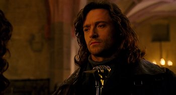 Movie still from “Van Helsing” (2004), directed by Stephen Sommers – A person holding a microphone; Close Up shot, Low angle