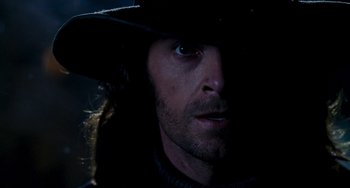 Movie still from “Van Helsing” (2004), directed by Stephen Sommers – A person wearing a hat and looking at the camera; Close Up shot, Low angle
