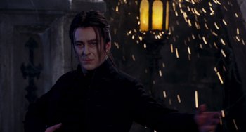 Movie still from “Van Helsing” (2004), directed by Stephen Sommers – A man standing in front of a street light; Medium shot, Low angle