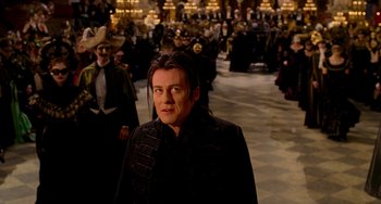 Movie still from “Van Helsing” (2004), directed by Stephen Sommers – A man standing in front of a group of people; Medium shot, Over the shoulder angle