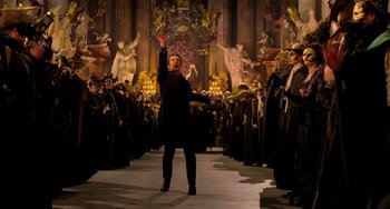 Movie still from “Van Helsing” (2004), directed by Stephen Sommers – A man in a crowd of people in a church; Wide shot, Low angle