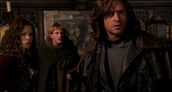 Movie still from “Van Helsing” (2004), directed by Stephen Sommers – Two men are standing next to each other in a room; Medium shot, Low angle