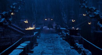 Movie still from “Van Helsing” (2004), directed by Stephen Sommers – A person walking down a dark path in the rain; Extreme Wide shot, High angle