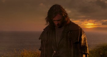 Movie still from “Van Helsing” (2004), directed by Stephen Sommers – A man with long dark hair standing on top of a hill; Medium shot, Low angle