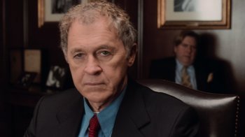 Movie still from “Vanilla Sky” (2001), directed by Cameron Crowe – An older man wearing a suit and tie in an office setting; Close Up shot, Over the shoulder angle
