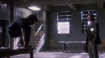 Movie still from “Vanilla Sky” (2001), directed by Cameron Crowe – A man standing on top of a bench in a room; Wide shot, Low angle