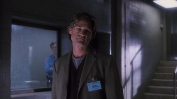 Movie still from “Vanilla Sky” (2001), directed by Cameron Crowe – A man in a suit and tie standing in front of a window; Medium shot, Over the shoulder angle