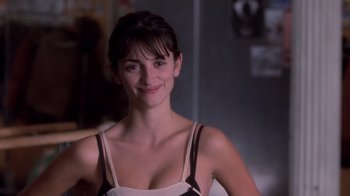 Movie still from “Vanilla Sky” (2001), directed by Cameron Crowe – A beautiful young lady smiling for the camera; Close Up shot, Over the shoulder angle