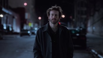 Movie still from “Vanilla Sky” (2001), directed by Cameron Crowe – A man in a black jacket standing in the street; Close Up shot, Low angle