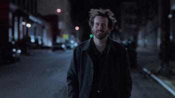 Movie still from “Vanilla Sky” (2001), directed by Cameron Crowe – A man in a black jacket is smiling for the camera; Close Up shot, Low angle