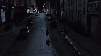 Movie still from “Vanilla Sky” (2001), directed by Cameron Crowe – A person is walking down the street at night; Extreme Wide shot, High angle