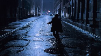 Movie still from “Vanilla Sky” (2001), directed by Cameron Crowe – A person walking down a street at night; Wide shot, High angle