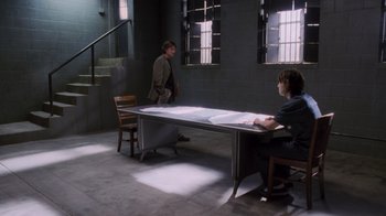 Movie still from “Vanilla Sky” (2001), directed by Cameron Crowe – Two people sitting at a table in a room; Wide shot, High angle
