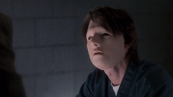 Movie still from “Vanilla Sky” (2001), directed by Cameron Crowe – A person with a face mask on looking at the camera; Close Up shot, Over the shoulder angle