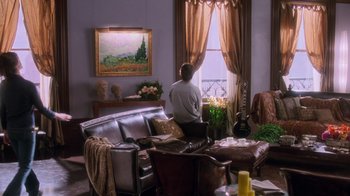 Movie still from “Vanilla Sky” (2001), directed by Cameron Crowe – A man sitting on a couch looking out a window; Wide shot, High angle