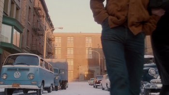 Movie still from “Vanilla Sky” (2001), directed by Cameron Crowe – A man standing on the side of the road in front of a building; Wide shot, Low angle