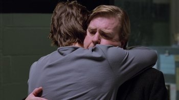 Movie still from “Vanilla Sky” (2001), directed by Cameron Crowe – Two men hugging each other in a dark room; Close Up shot, Over the shoulder angle