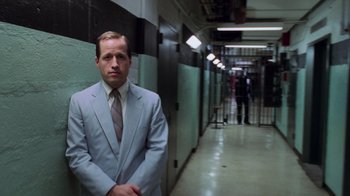 Movie still from “Vanilla Sky” (2001), directed by Cameron Crowe – A man in a suit and tie standing in a hallway; Medium shot, Low angle