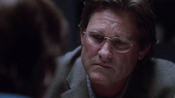 Movie still from “Vanilla Sky” (2001), directed by Cameron Crowe – A person wearing a suit and glasses; Close Up shot, Over the shoulder angle