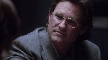 Movie still from “Vanilla Sky” (2001), directed by Cameron Crowe – A person wearing a suit and glasses; Close Up shot, Low angle