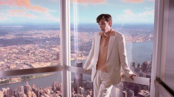 Movie still from “Vanilla Sky” (2001), directed by Cameron Crowe – A man in a white suit standing in front of a window; Medium shot, High angle