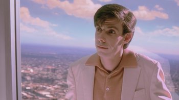 Movie still from “Vanilla Sky” (2001), directed by Cameron Crowe – A man in a white jacket looking at the sky; Close Up shot, Low angle