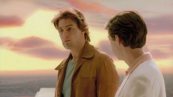 Movie still from “Vanilla Sky” (2001), directed by Cameron Crowe – Two men standing next to each other in front of a sunset; Medium shot, Over the shoulder angle