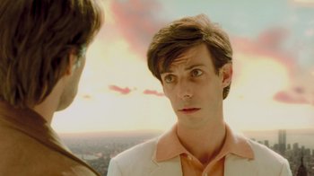 Movie still from “Vanilla Sky” (2001), directed by Cameron Crowe – A man in a white jacket looking at another man in an orange shirt; Close Up shot, Over the shoulder angle