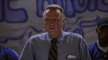 Movie still from “Varsity Blues” (1999), directed by Brian Robbins – A man in a blue shirt and a black tie; Close Up shot, Low angle