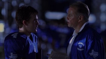 Movie still from “Varsity Blues” (1999), directed by Brian Robbins – A man and a boy talking to each other; Medium shot, Over the shoulder angle
