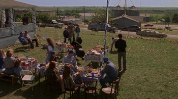 Movie still from “Varsity Blues” (1999), directed by Brian Robbins – A group of people sitting at a table with plates of food on it; Extreme Wide shot, High angle