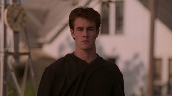 Movie still from “Varsity Blues” (1999), directed by Brian Robbins – A young man wearing a black shirt is looking at the camera; Close Up shot, Low angle