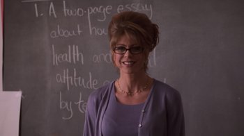 Movie still from “Varsity Blues” (1999), directed by Brian Robbins – A woman standing in front of a chalkboard; Close Up shot, Over the shoulder angle