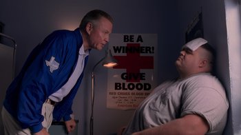 Movie still from “Varsity Blues” (1999), directed by Brian Robbins – Two men are standing in front of each other; Medium shot, Low angle