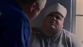 Movie still from “Varsity Blues” (1999), directed by Brian Robbins – A man in a white hat looking at his reflection in a mirror; Close Up shot, Over the shoulder angle