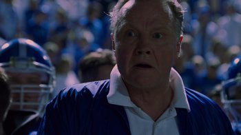 Movie still from “Varsity Blues” (1999), directed by Brian Robbins – An older man in a crowd of people; Close Up shot, Low angle