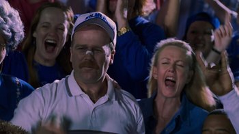 Movie still from “Varsity Blues” (1999), directed by Brian Robbins – A group of people that are sitting in front of a crowd; Close Up shot, Low angle
