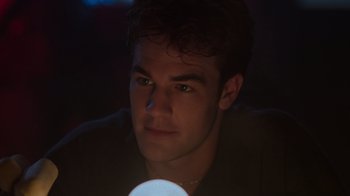 Movie still from “Varsity Blues” (1999), directed by Brian Robbins – A young man is looking at the camera with a flashlight in his hand; Close Up shot, Low angle