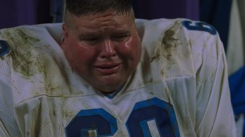 Movie still from “Varsity Blues” (1999), directed by Brian Robbins – A person with a football jersey crying; Close Up shot, Low angle