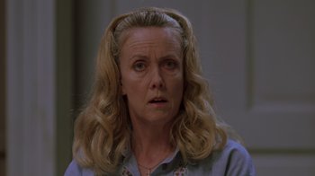 Movie still from “Varsity Blues” (1999), directed by Brian Robbins – An older woman with long blonde hair wearing a blue shirt and pigtails; Close Up shot, Low angle