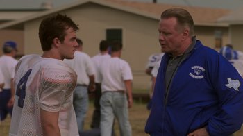 Movie still from “Varsity Blues” (1999), directed by Brian Robbins – A man and a boy talking to each other outside; Medium shot, Over the shoulder angle