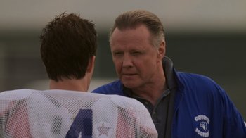 Movie still from “Varsity Blues” (1999), directed by Brian Robbins – A man talking to another man in front of a building; Close Up shot, Over the shoulder angle