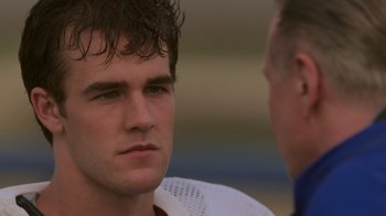 Movie still from “Varsity Blues” (1999), directed by Brian Robbins – A man in a white shirt and a man in a blue shirt; Close Up shot, Over the shoulder angle