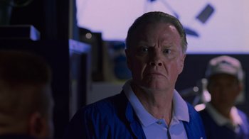 Movie still from “Varsity Blues” (1999), directed by Brian Robbins – An older man in a white shirt and a blue jacket; Close Up shot, Low angle