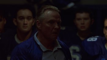 Movie still from “Varsity Blues” (1999), directed by Brian Robbins – A group of men standing next to each other in a room; Close Up shot, Low angle