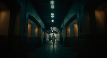 Movie still from “Venom: Let There Be Carnage” (2021), directed by Andy Serkis – A person walking down a hallway in a building; Extreme Wide shot, Low angle