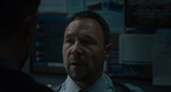 Movie still from “Venom: Let There Be Carnage” (2021), directed by Andy Serkis – A person wearing a suit and tie; Close Up shot, Over the shoulder angle