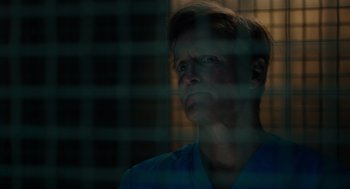 Movie still from “Venom: Let There Be Carnage” (2021), directed by Andy Serkis – A man in a blue shirt looking out of a window; Close Up shot, Low angle