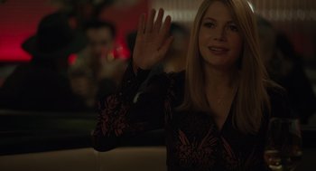 Movie still from “Venom: Let There Be Carnage” (2021), directed by Andy Serkis – A beautiful blonde woman waving at the camera; Medium shot, Over the shoulder angle