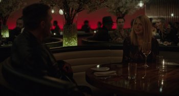 Movie still from “Venom: Let There Be Carnage” (2021), directed by Andy Serkis – A group of people sitting at a table in a restaurant; Medium shot, Over the shoulder angle